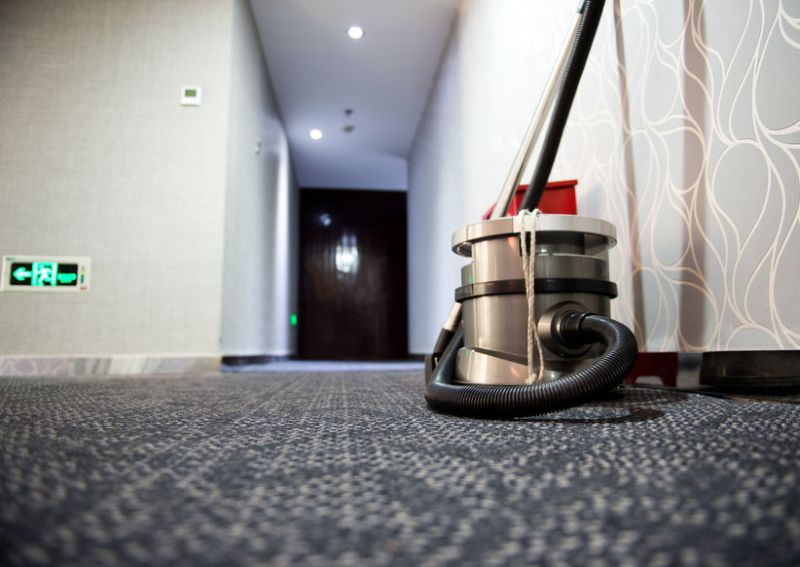 24905654 - vacuum cleaner stands in the hotel corridor.